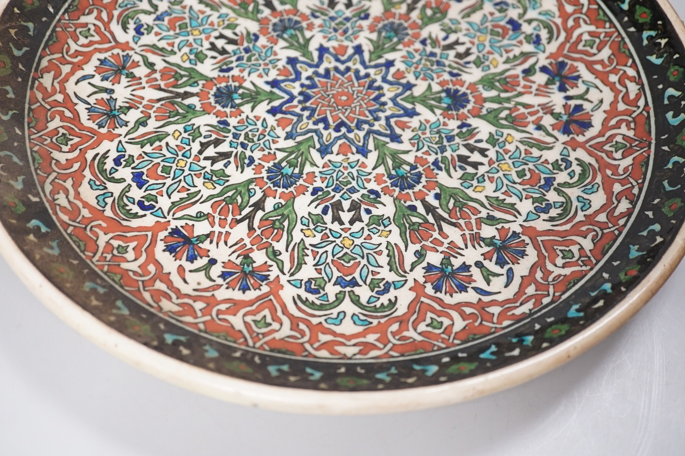 A Kütahya pottery dish, the back marked Azim Kütahya, diameter 31cm